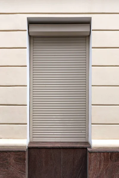 Window with roller shutters on white background