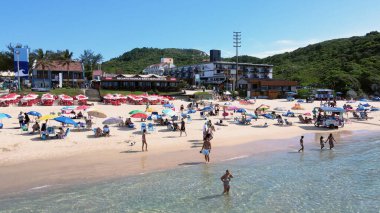 Florianopolis, Santa Catarina 'daki Joaquina Sahili' nin havadan görünüşü, birçok turkuaz mavi denizle güneşli bir yaz gününün tadını çıkaran insanlarla dolu..