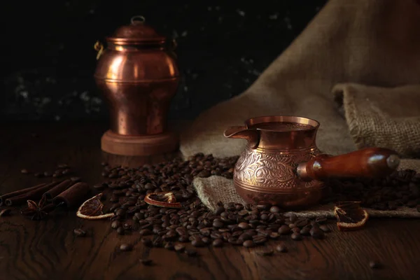 Cezve-traditional cup of coffee, bag and scoop on old rusty background. Dark food photography. — Stock Photo, Image