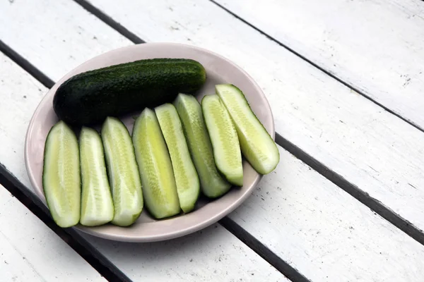 Cucumber on wooden table at the plate and vintage background. Selective focus on cucumber — Stock Photo, Image