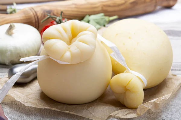 Italian provolone or provola caciocavallo hard cheeses in teardr — Stock Photo, Image