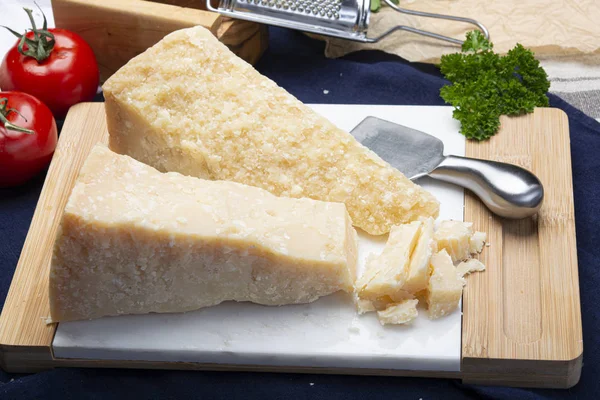 Italian original aged Parmesan cheese in two pieces close up