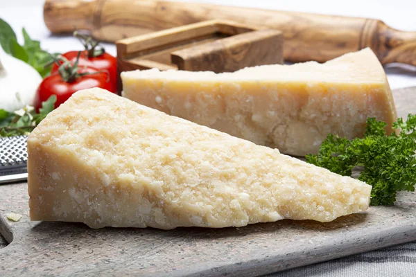 Italian original aged Parmesan cheese in two pieces close up