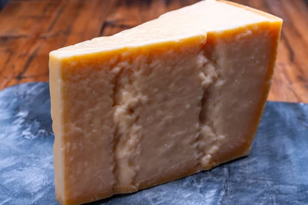パルミジャーノ レッジャーノ パルメザン ハードの大きなくさび牛乳やグラナパダーノから作られたイタリアのチーズを閉じます — ストック写真