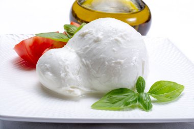 Güney İtalya 'nın Campania, Paestrum ve Foggia bölgelerinden gelen taze İtalyan peynirli mozzarella bufalosu domates, taze fesleğen ve zeytinyağı ile servis edilir.
