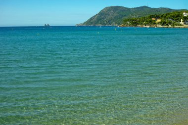 Güneşli kumlu sahil tatili, berrak mavi deniz kıyıları ve kumlu plajları olan manzara, kimse yok.