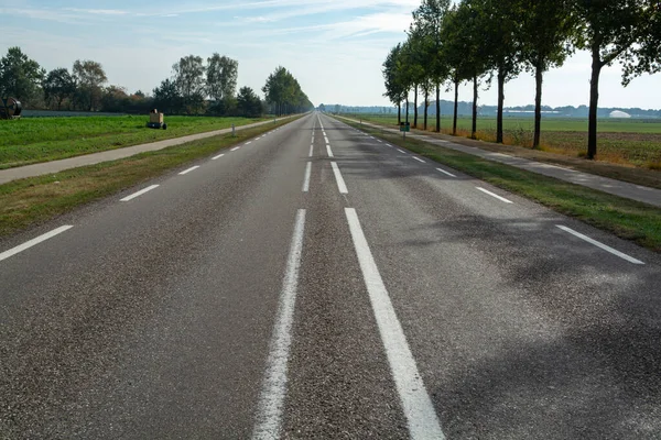 Road network in Netherlands, high quality roads in countryside, landscape with fields, road and separate bicycle line