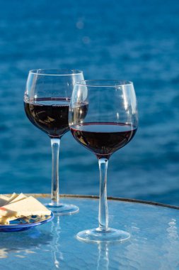 Aperatif, bardakta kırmızı şarap, açık hava tessace peynirle servis edilir. Deniz manzarası kapalı.