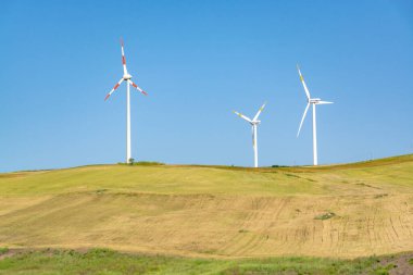 Büyük rüzgar türbinleri kuleleri olan modern rüzgar çiftliği yenilenebilir yeşil enerji kaynağı