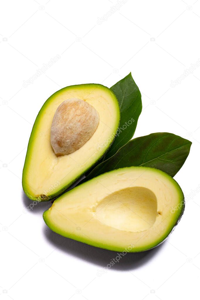 Fresh organic ripe green whole and sliced Fuerte avocado with leaves, copy space close up isolated on white background