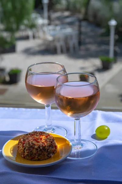 Rose wine of Provence, France, served cold on outdoor terrace in two wine glasses on sunny day