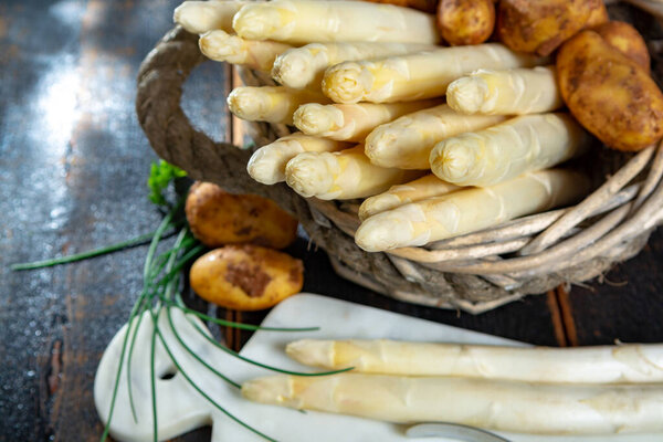 Fresh tasty white asparagus and potatoes, seasonal vegetable, new harvest, ready to cook