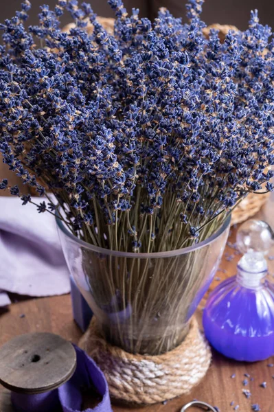 Vase with bunch of purple dried aromatic lavender flowers in gift shop in Provence, France dark key