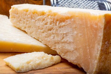 Orijinal İtalyan peyniri, yıllanmış parmesan inek sütü peyniri, Parmigiano-Reggiano parçaları yakın plan.