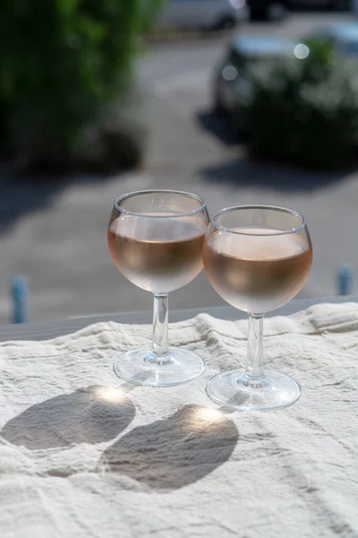 Rose wine of Provence, France, served cold on outdoor terrace in two wine glasses in sunny day