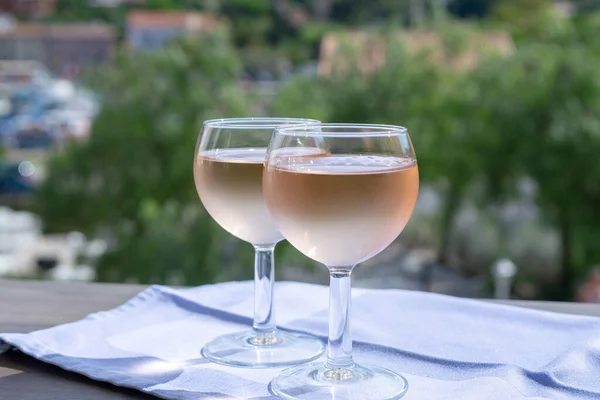 Rose wine of Provence, France, served cold on outdoor terrace in two wine glasses in sunny day