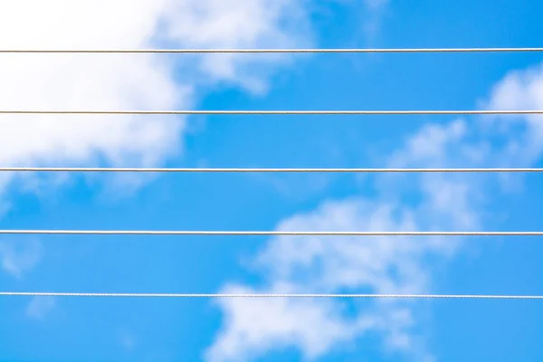 Empty music staff concept photo of 5 electric wires on blue sky, music creation template copy space