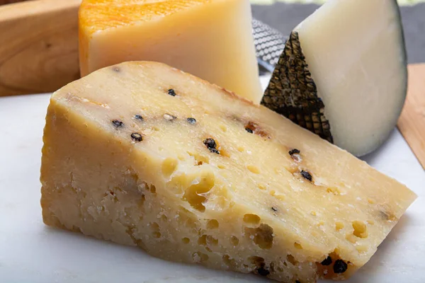 Cheese collection, Variety of Italian pecorino cheeses, aged with black peppers from Nebrodi, white Il Palio and black molarotto, close up