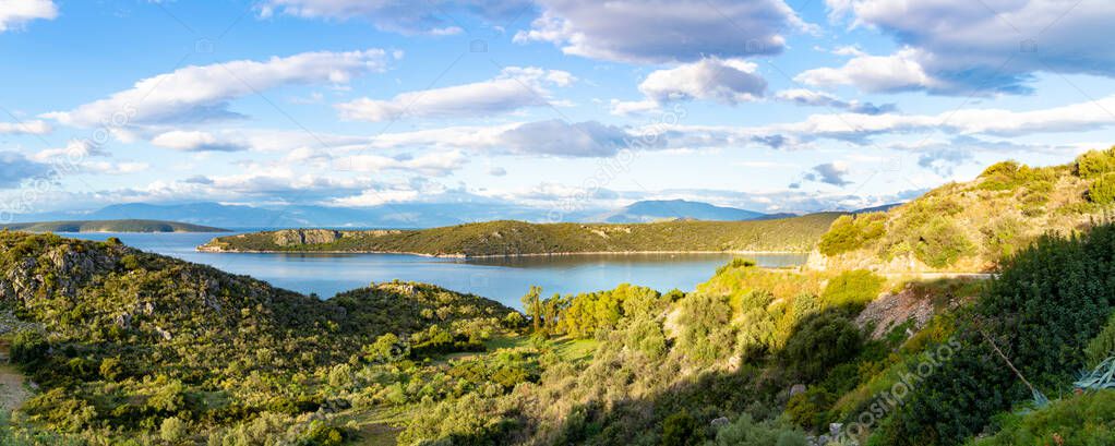 Panorama photo with scenic coastline on Peloponnese, Greece, green hills and blue sea water