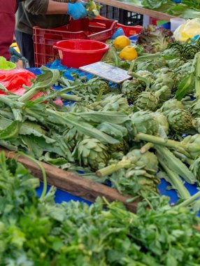 Enginar çiftliğinden taze çiğ enginar başları, Yunanistan 'ın Argolida kentindeki tarım pazarında yeni hasat.