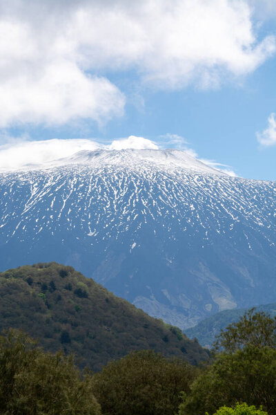 View on active stratovolcano Mount Etna on east coast of island Sicily, Italy in spring