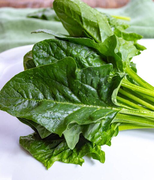 Bunch of green fresh organic spinach leaves close up