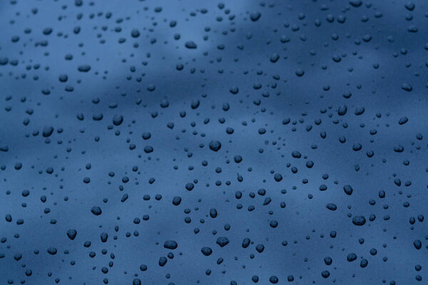 Abstract background with water drops on metal surface close up