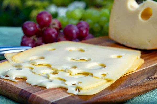 Dutch Maasdam Hard Cheese Holes Piece Sliced Served Grapes Outdoor — Stock Photo, Image