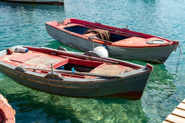 Seascape with pier, quiet sea harbor with clear transparent water and traditional greek fisher boats