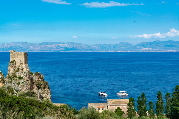 Scenic coastline with rocks and deep blue sea near Castellamare del Golfo by entrance to natural reserve Zingaro, Sicily, Italy