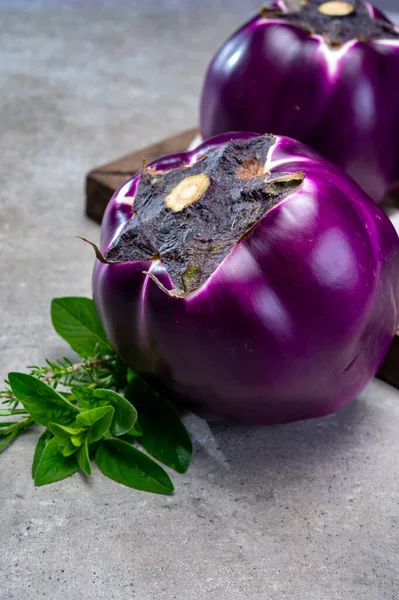 Fresh ripe sicilian purple globe eggplants vegetables ready to cook, healthy Italian food