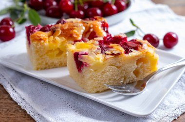 Taze pişmiş kek ve kırmızı sulu ekşi kiraz veya kriek meyveli yakın çekim.