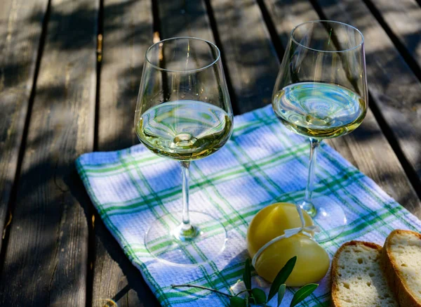 Summer picnic or outdoor lunch with tasting of white wine on green vineyards in Lazio, Italy