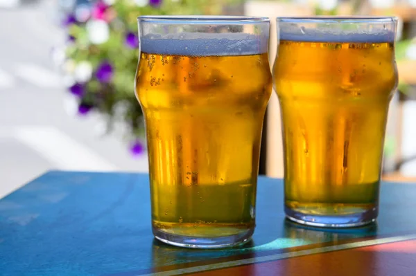 French cold beer in misted glasses served on outdoor terrace in small Alpine village in France close up