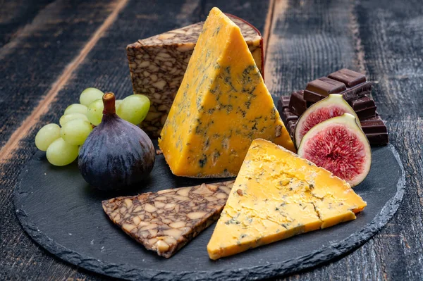British and Irish cheeses, tasting plate with blue shropshire, brown porter cheese and smoked cheddar close up