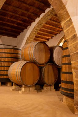Eski büyük meşe fıçılarıyla şarap mahzeni ziyareti, Marsala, Sicilya 'da güçlendirilmiş kuru veya tatlı marsala şarabı üretimi, İtalya' da şarap endüstrisi