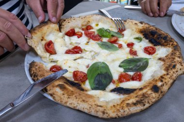 İtalyan pizzacıda fırın fırını, fırın, pizza ve pizza yemek. Kapatın.