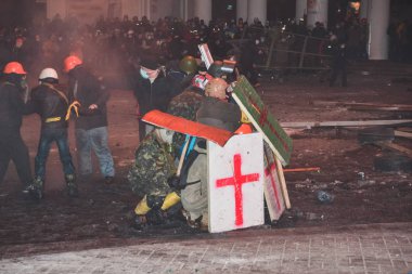 Ukraine, Kiev, January 19 2014: Clash during the protests against President Yanukovych in Kyiv on the street Grushevskogo clipart