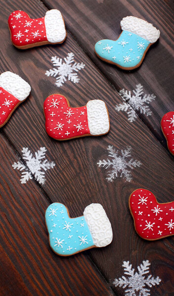 Many Gingerbread cookies boots with caramel sticks over wooden background.Sweet Background.Closeup.Christmas background