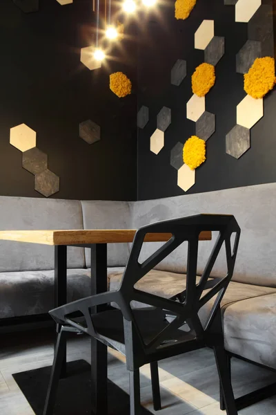 Interior of cafe . Loft space design, wooden table, concrete wall. creative minimalistic cafe interior, simplicity and geometry concept, black and yellow colors.Creative space