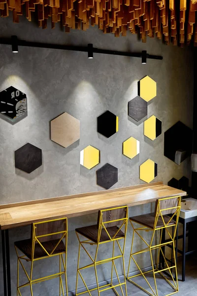 Interior of cafe . Loft space design, wooden table, concrete wall. creative minimalistic cafe interior, simplicity and geometry concept, black and yellow colors.Creative space