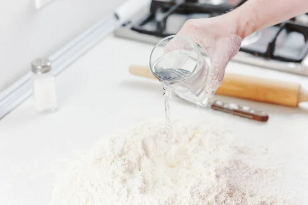 Hands chef knead dough for pizza. Knead dough with your hands. Woman\'s hands knead dough. Cooking pizza.