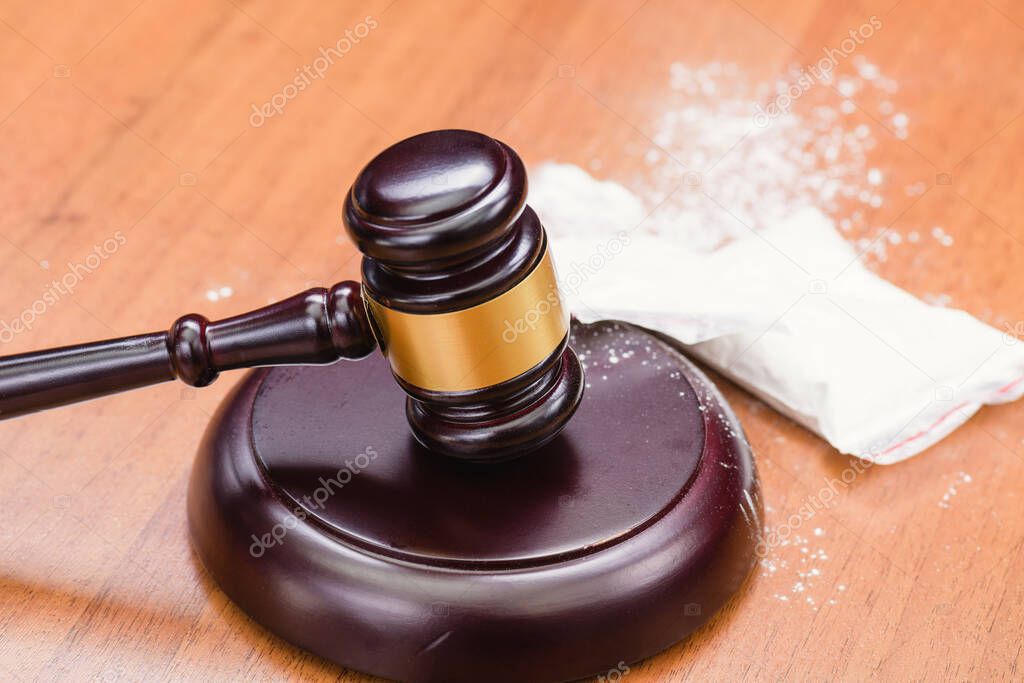 White powder on the judge's gavel. Drugs on the table of the judge. Court for the sale of drugs. Verdict for the distribution of drugs. 