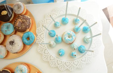 Renkli çörekler ve pasta tatlı masada.