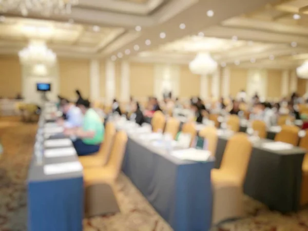 Education concept, Abstract blurred background image of students and business people  studying and discuss in large hall profession seminar with screen and projector for showing information.