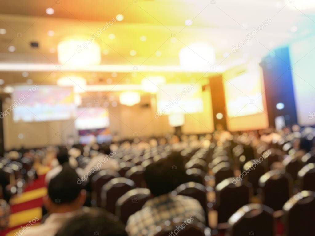 Education concept, Abstract blurred background image of students and business people  studying and discuss in large hall profession seminar with screen and projector for showing information.