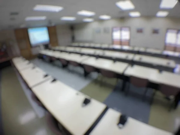 Abstract background blurred image of  modern conference room or seminar room before meeting with table and chair. Blur row of empty seat in auditorium or hall or classroom. vintage tone color.