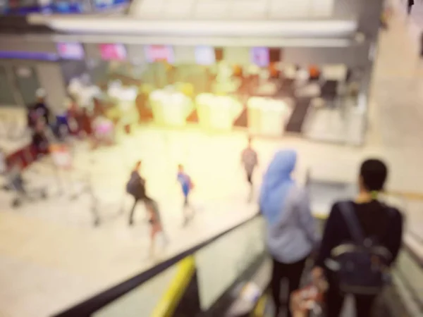 Abstract Blur Background of people or passenger walking in or hurry up in airport transport terminal, Airport Check-In Counters With Many Passengers With Bokeh. vintage tone with light effect