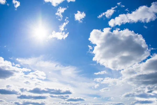 Cloudy sky with natural sun flare. Clouds. Free sky. Background.