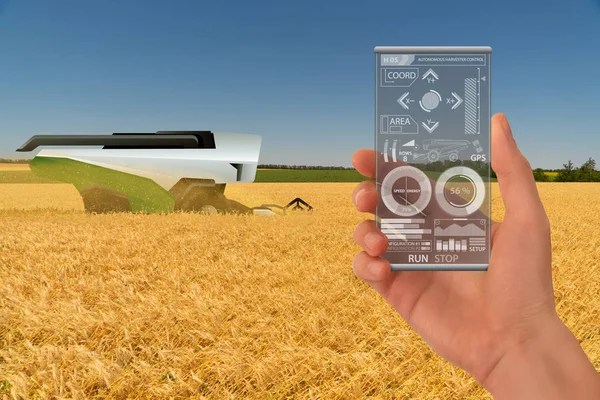 Farmer controls autonomous harvester. — Stock Photo, Image